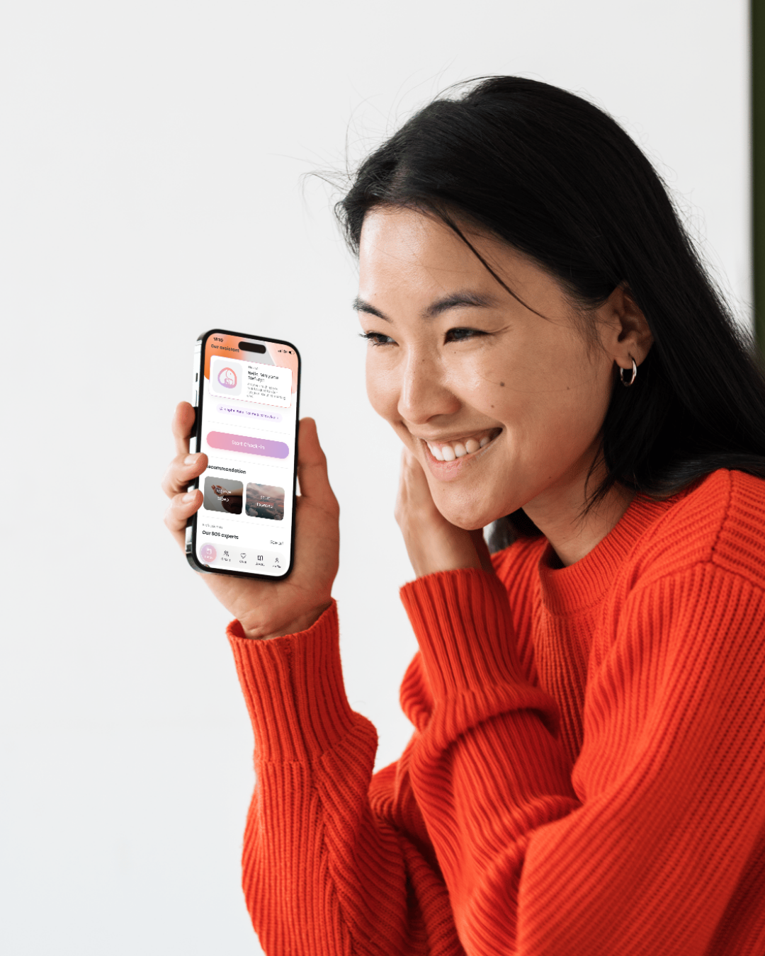 Woman holding iPhone displaying elephAi app